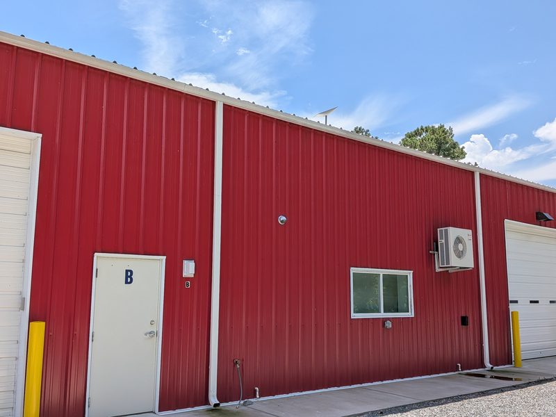 Starlink installed on a commercial building, dish clear of the roof edge